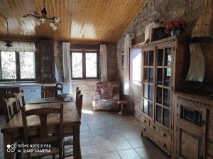 a kitchen with a table and a wooden ceiling at La Torre del Algas in Nonaspe