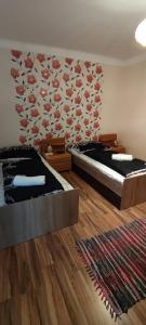 A bed or beds in a room at Orsi Apartman / vendegház