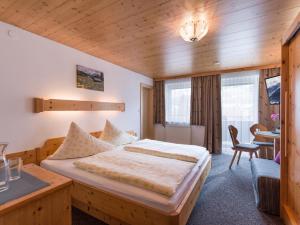 a hotel room with a bed and a table at Gästehaus Roland in Kirchberg in Tirol