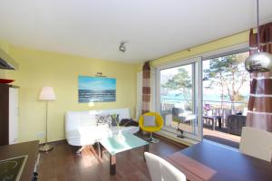 a living room with a white couch and a table at F-1072 Haus am Strand in Juliusruh Whg 06 in Juliusruh