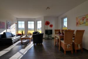 a living room with a couch and a table at F-1084 Ferienwohnungen Ruegenreif Nr 01 in Klein Zicker