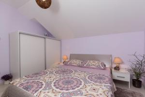 een witte slaapkamer met een groot bed en 2 lampen bij Cetinic Apartment in Dubrovnik