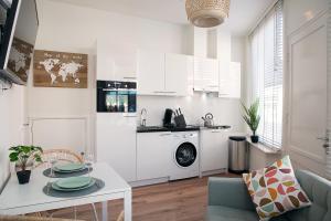 a living room with a table and a kitchen at Charming beach getaway in Scheveningen +9 photos