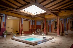 a large room with a swimming pool in a building at Appartamento Impluvium in Lido di Ostia