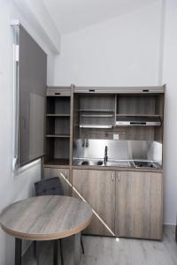 a kitchen with a wooden table and a wooden counter top at GERANI apartments in Órmos