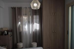 a bedroom with a shower and a chandelier at Sweet Memories in Malia