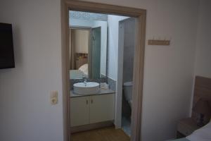 a bathroom with a sink and a mirror at Sweet Memories in Malia