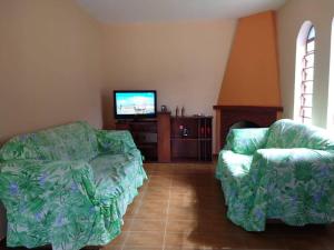 En eller flere senger på et rom på Chácara recanto da família