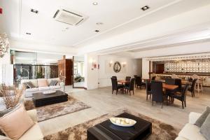 a living room filled with furniture and a dining room at Sercotel Hotel President in Figueres