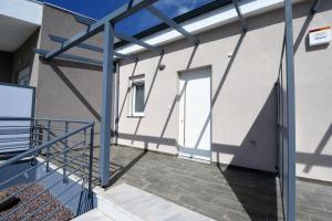 a balcony of a building with blue metal railing at GERANI apartments in Órmos
