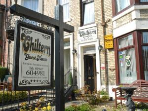 a sign for a restaurant in front of a building at Chiltern Guest House in Whitby