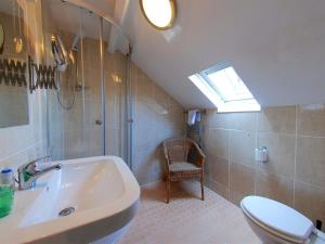 a bathroom with a sink and a toilet and a window at Chiltern Guest House in Whitby