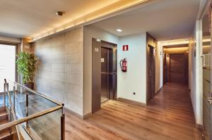 a hallway with wood floors and a staircase at Hotel Julimar in Lloret de Mar