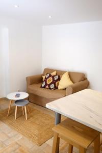 a living room with a couch and a table at Proa d'Alfama Guest House in Lisbon