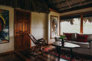 a living room with a couch and a table at Gaia Riverlodge in San Ignacio