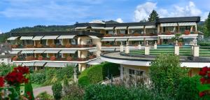 a large building with a garden in front of it at Relais & Châteaux Hotel Schwarzmatt in Badenweiler