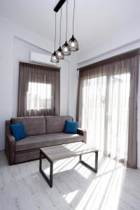 a living room with a couch and a coffee table at GERANI apartments in Órmos
