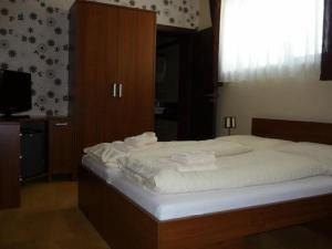 Postel nebo postele na pokoji v ubytování Hotel Galanta