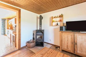 a living room with a wood stove in a room at Deichgraf 1 in Friedrichskoog