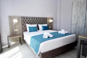 a bedroom with a large bed with two pillows on it at GERANI apartments in Órmos