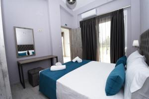 a bedroom with a large bed and a fireplace at GERANI apartments in Órmos