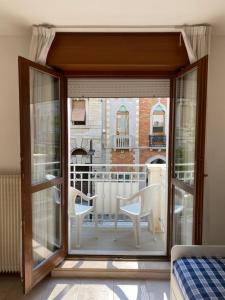 a room with a view of a balcony at Europa Unita Apartment in Grado