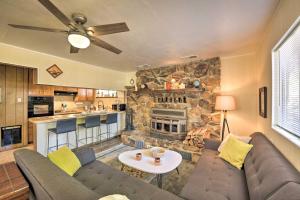 a living room with a couch and a stone fireplace at Balcony and Forest Views Cabin in Pioneer! in Pioneer