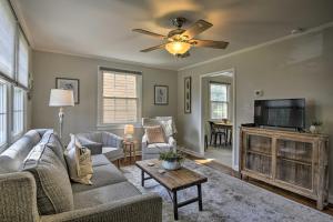 a living room with a couch and a flat screen tv at Raleigh ITB Home - Mins to Downtown and North Hills! in Raleigh