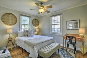 a bedroom with a bed with a ceiling fan and a desk at Raleigh ITB Home - Mins to Downtown and North Hills! in Raleigh