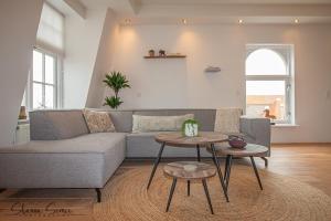 a living room filled with furniture and a table at Penthouse Apartment "Trendy" Alkmaar by Urban Home Stay in Alkmaar