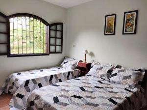 Säng eller sängar i ett rum på Sítio entre Santo Antonio Pinhal e Campos do Jordão