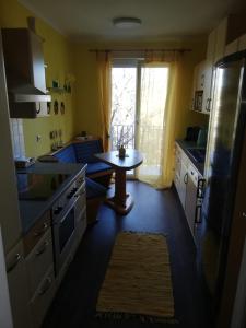 a kitchen with a table and a small table in it at Apartment Graz Lustbuhel in Graz