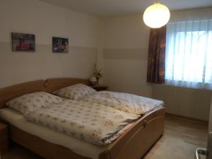 Bett in einem Schlafzimmer mit Licht in der Unterkunft Ferienwohnung Gaby Familie Wichtl in Riedlhütte