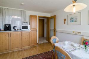 a kitchen with a table and a microwave at Ferienwohnung Munding in Überlingen