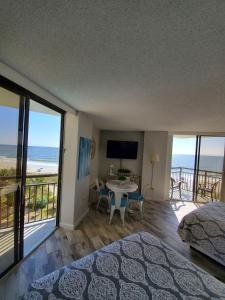 a bedroom with a bed and a view of the ocean at 426 Belle Vue Magnificent Oceanfront studio with two balconies in Myrtle Beach
