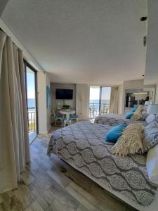 a bedroom with a bed with a view of the ocean at 426 Belle Vue Magnificent Oceanfront studio with two balconies in Myrtle Beach