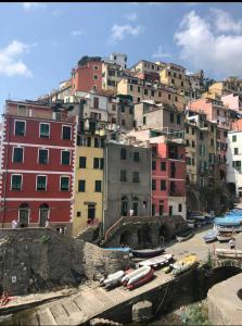 a group of buildings with boats in a harbor at Casa D'amore in Riomaggiore