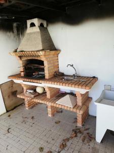 a brick oven in a kitchen with a sink at Moradia São Pedro in Porto Santo