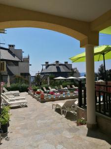 ソゾポルにあるApartments Elinor Budjakaのパティオ(ラウンジチェア、パラソル付)