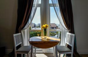 a table and two chairs in front of a window at Hillcrest Whitby in Whitby