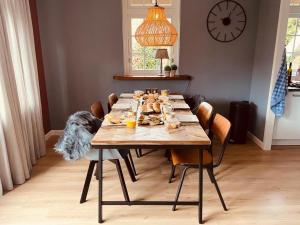 a dining room table with plates of food on it at Vakantiehuis 6 personen in de Achterhoek met sauna in Lievelde
