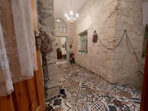 a hallway with a tile floor in a building at Al Bishara Guest House in Nazareth