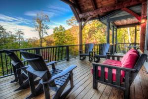 a porch with chairs and a couch on a deck at Rustic Timber in Montreat