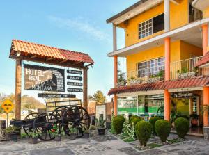 a hotel with a sign on the side of a building at Hotel Real de la Montaña in San Miguel Regla