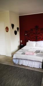 una camera da letto con un letto con cuori appesi al muro di La Cour du Puits, chambre Colyn a Cormeilles