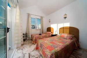 A bed or beds in a room at Villa Calma by Villa Plus Még 19 kép