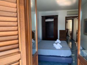 a bedroom with a bed and a dresser at Oltremare Residence Hotel in Canneto