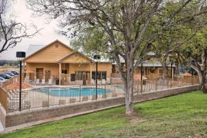 a fence around a swimming pool in front of a house at WorldMark New Braunfels in New Braunfels