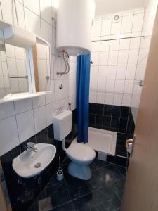 a bathroom with a toilet and a sink and a tub at Apartments with sea view Drvenik Makarska riviera in Drvenik +79 photos
