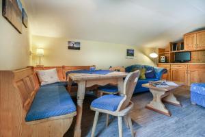 a living room with a table and a couch at Haus Wiesenrand Kurz in Berchtesgaden